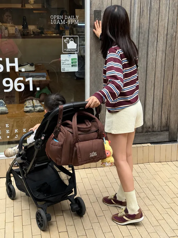 Midnight Brownie bag on a stroller outside a shop