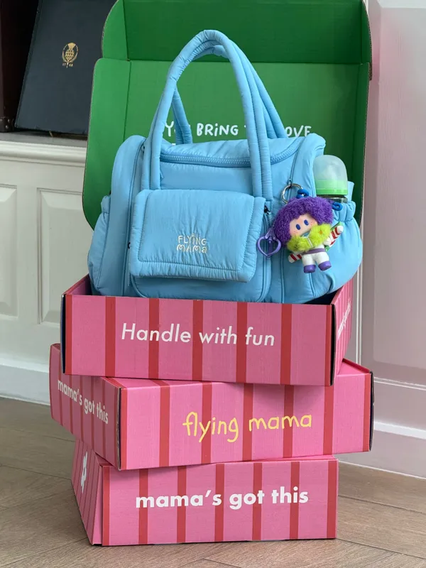Bubblegum Blue bag on striped Flying Mama boxes