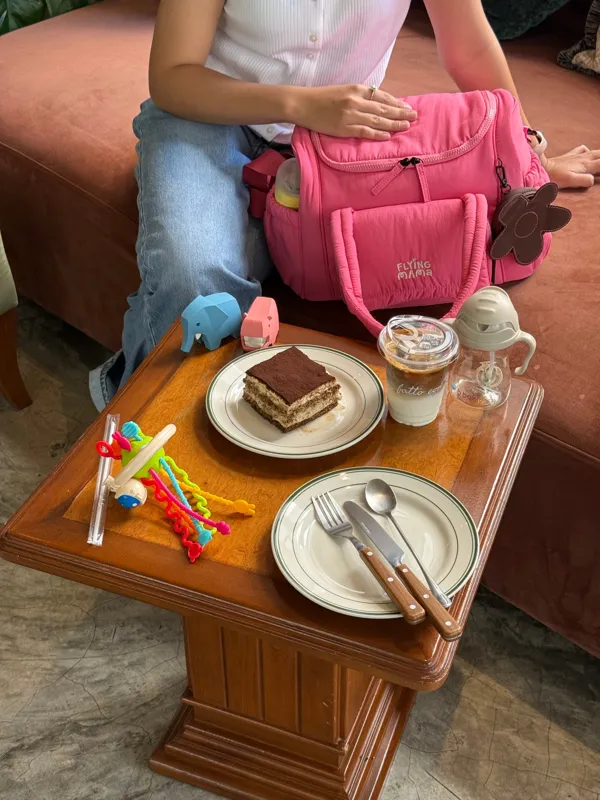 Raspberry Jam bag at a café table